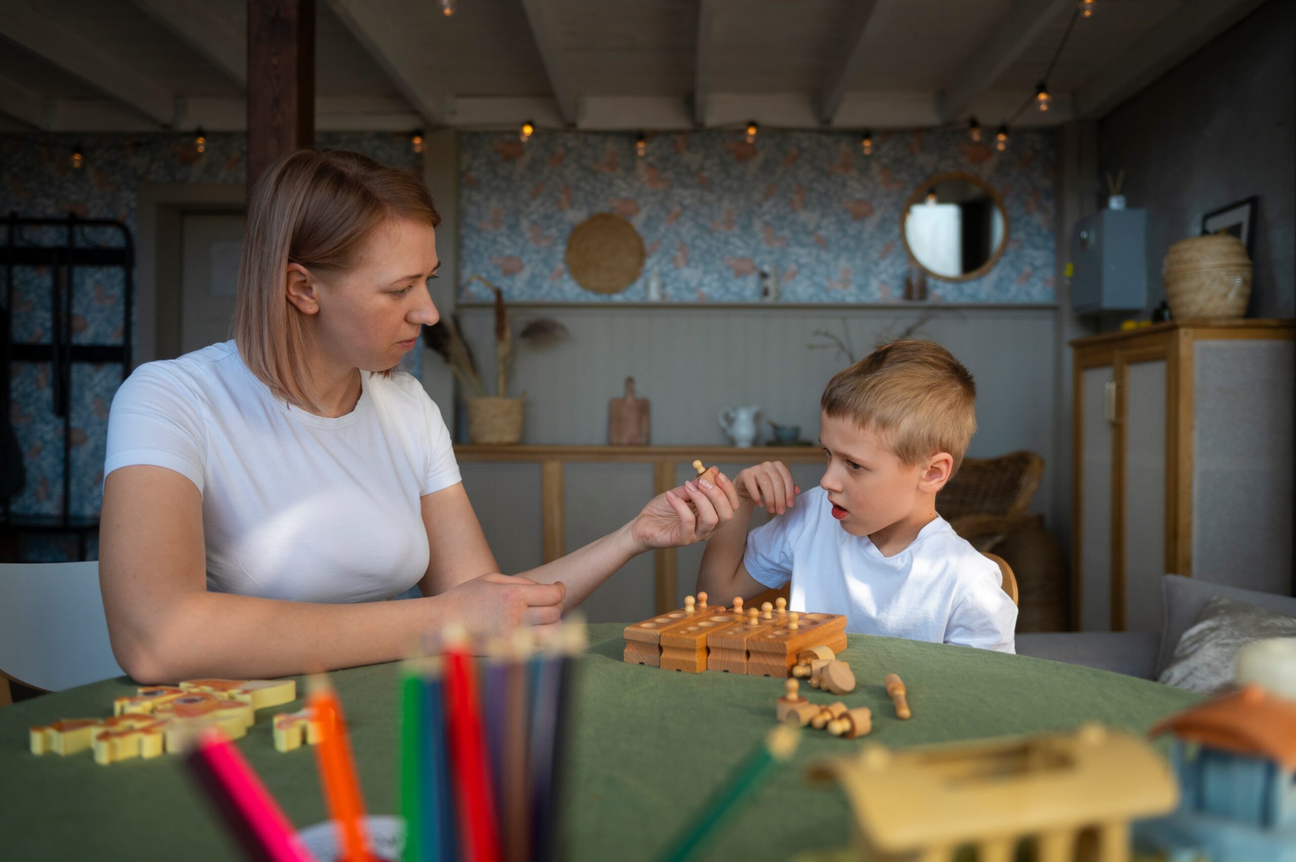 mother playing with her autistic son using toys 1 scaled